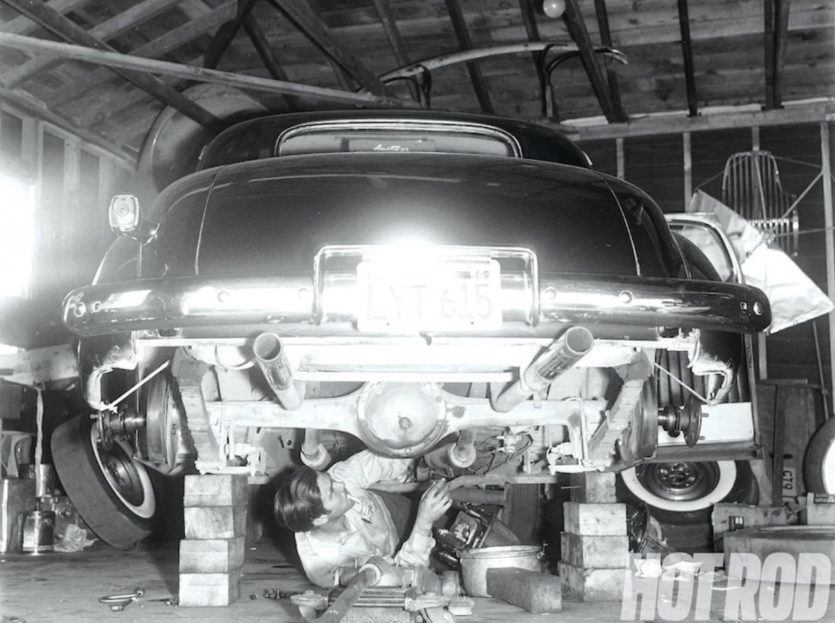 18 Doug cookie cook working on his 37 Chevy on blocks in his home garage.jpg