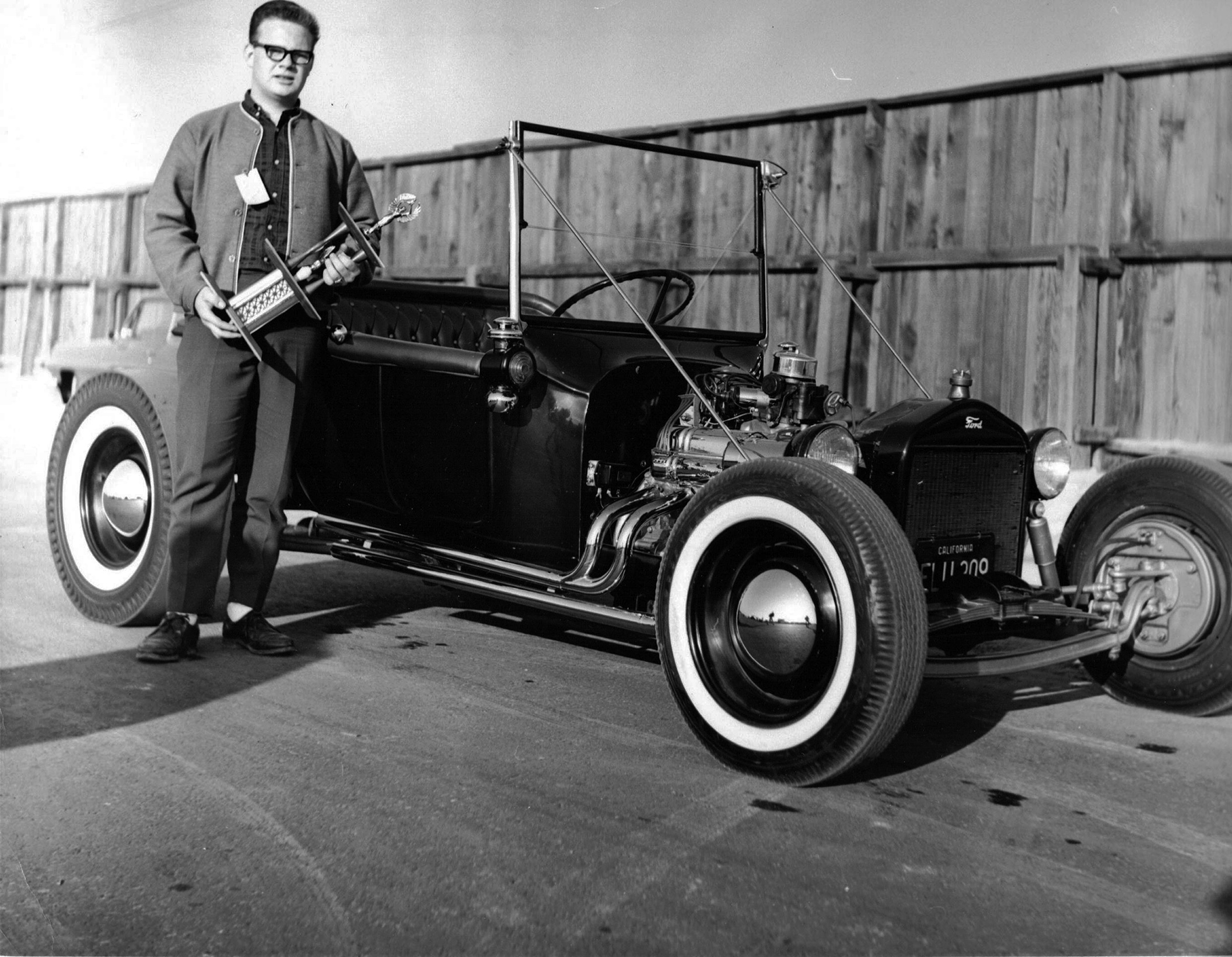 1922 T-bucket and Owner Holding a Trophy.jpg
