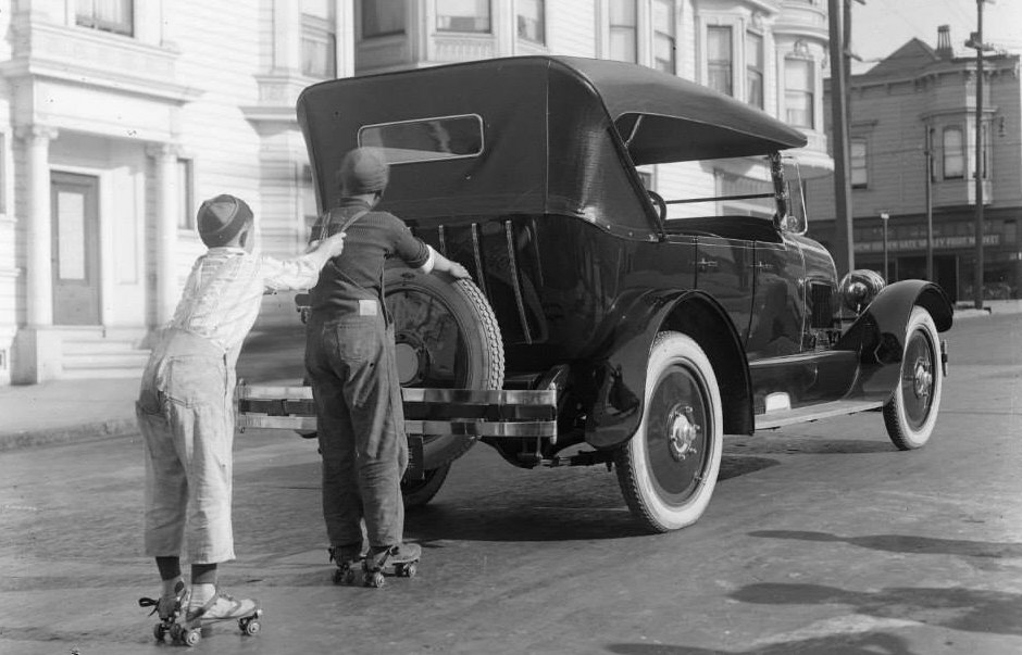 1930 kids on roller skates hitching a ride.jpg