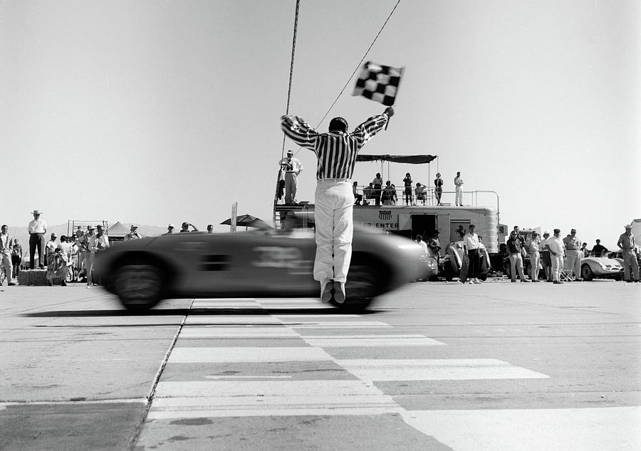 1960s-man-jumping-waving-checkered-flag-vintage-images.jpg