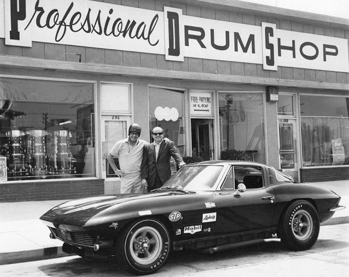 1963 split window in front iof a drum shop Whats up with that helmet.jpg