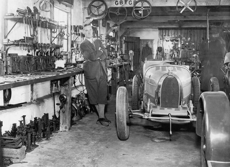 47 Famous record setter Sir Malcom Campbell with a Bugatti in a garage setting..JPG