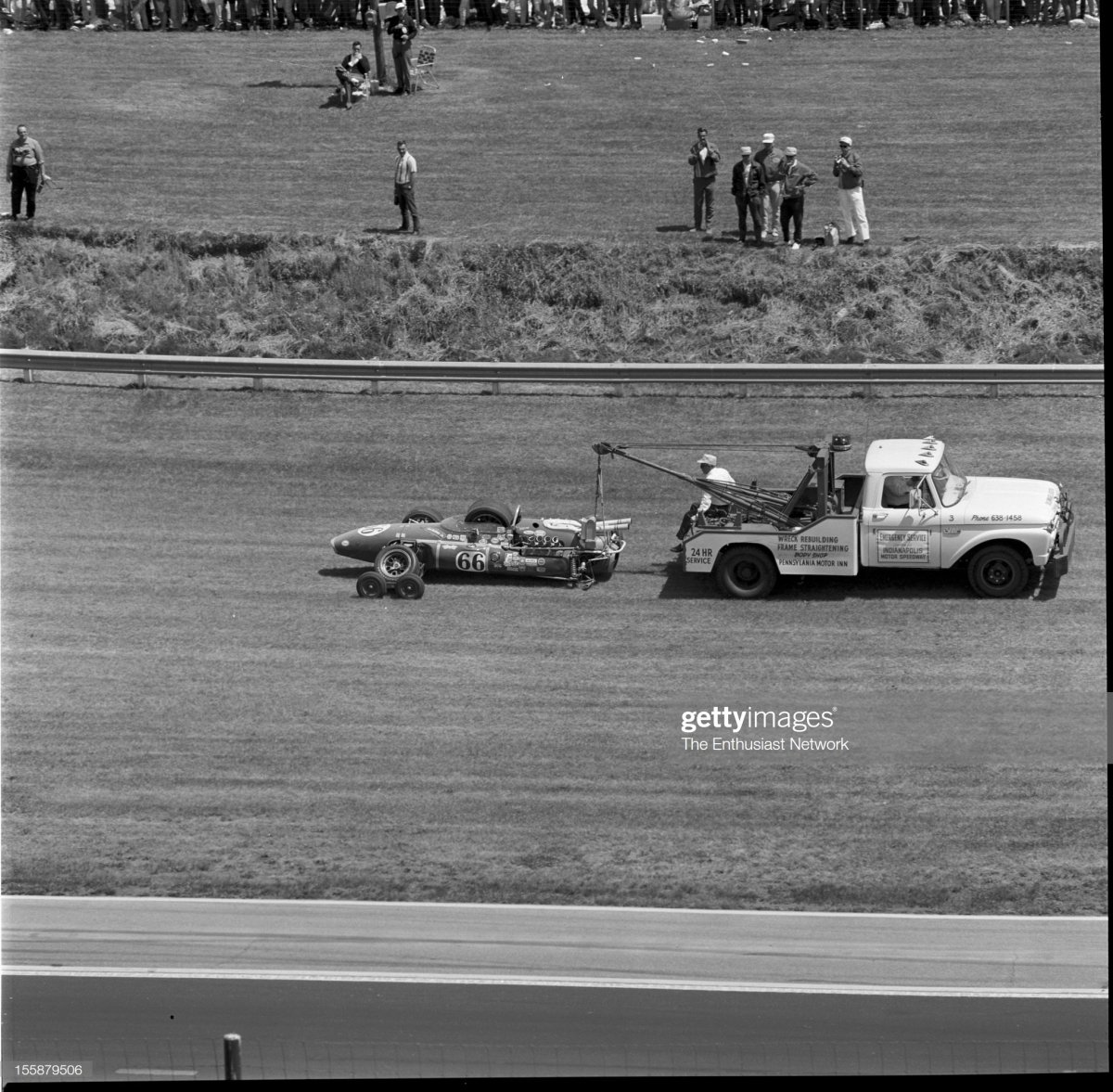 67  Track crews tow away the remains of Cale Yarborough's Vollstedt 65.jpg