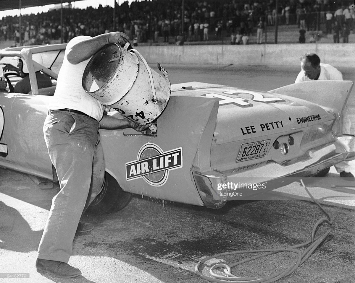 76 1960 Lee Petty’s Plymouth is refueled on a pit stop during the Rebel 300 NASCAR.jpg