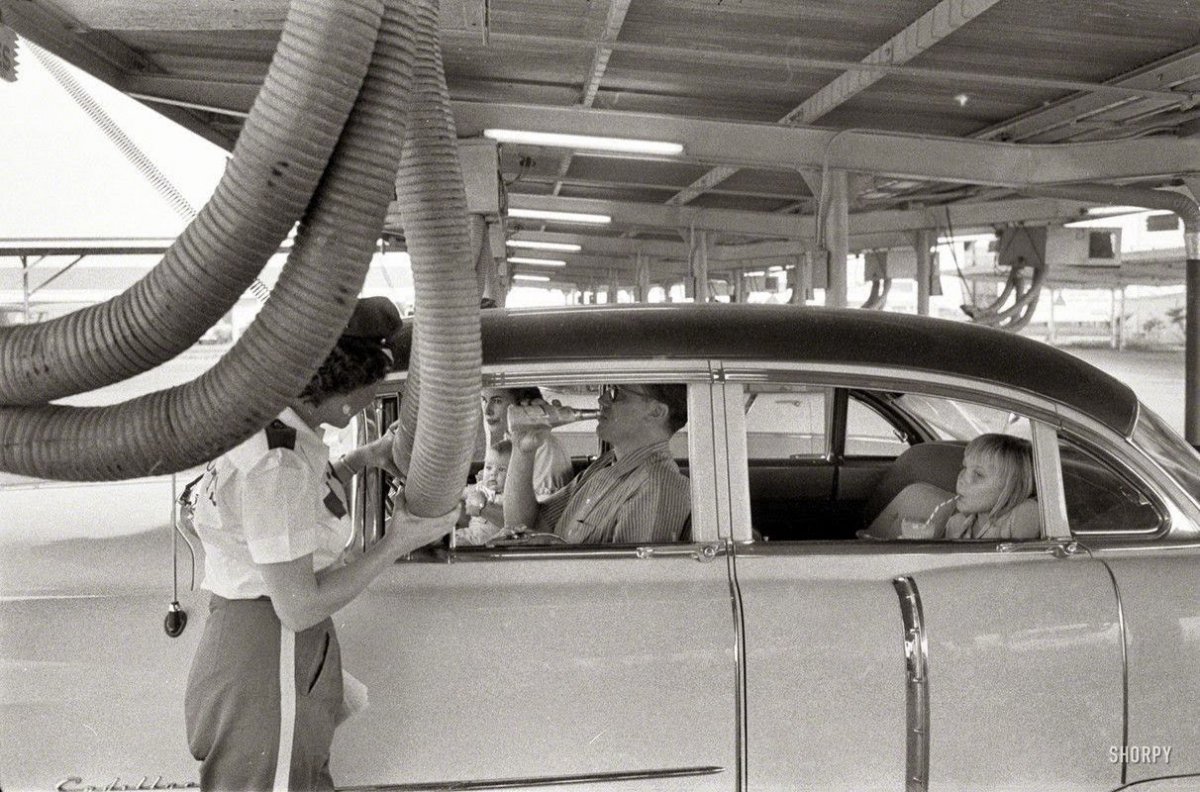 A family in Houston at a drive-in restaurant having cool air piped into their car, 1957.jpg