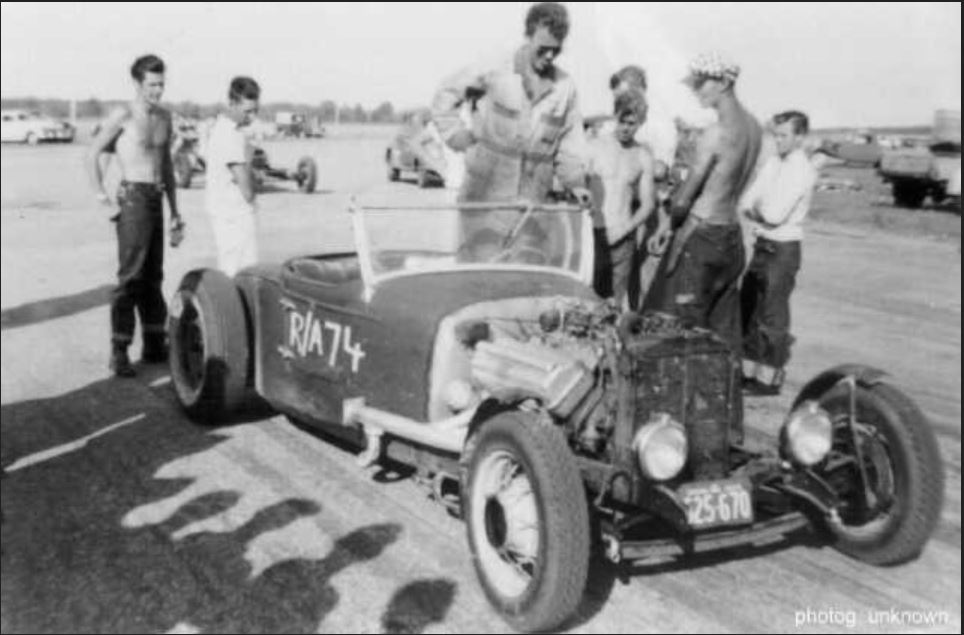 Bob Leverich with no shirt to the right of the driv.JPG