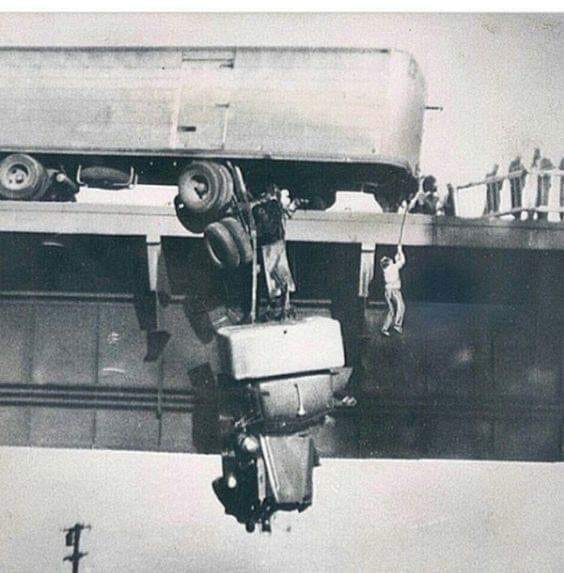 cars trucks truck dangling driver being hoisted.jpg