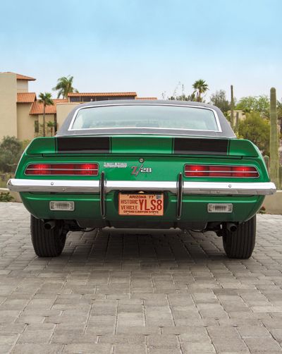 color-image-of-a-1969-chevrolet-camaro-z-28-rear-of-the-car-house-and-trees-in-background.jpg