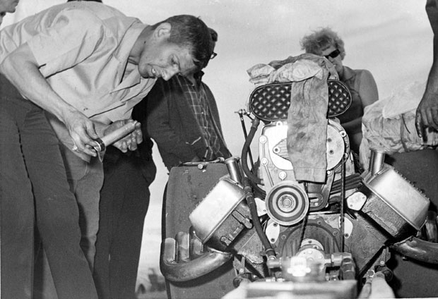 Eddie Hill checks out some engine parts between runs at an event in 1966..jpg