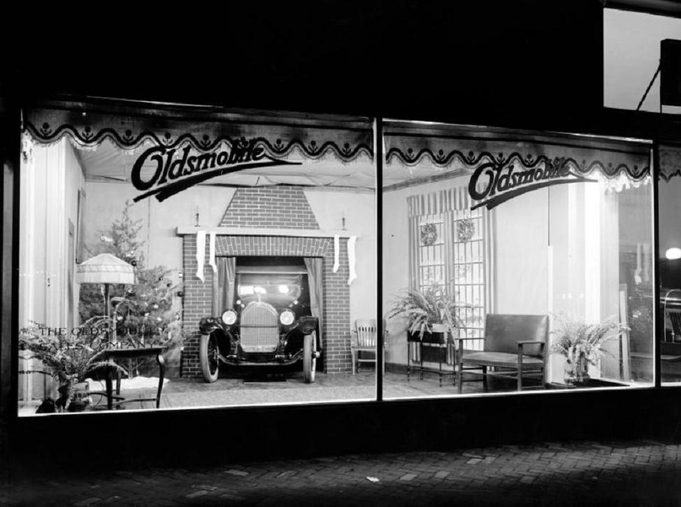 holiday Christmas car dealership 1927 Olds MAYBE YEAR Christmas tree showroom.jpg