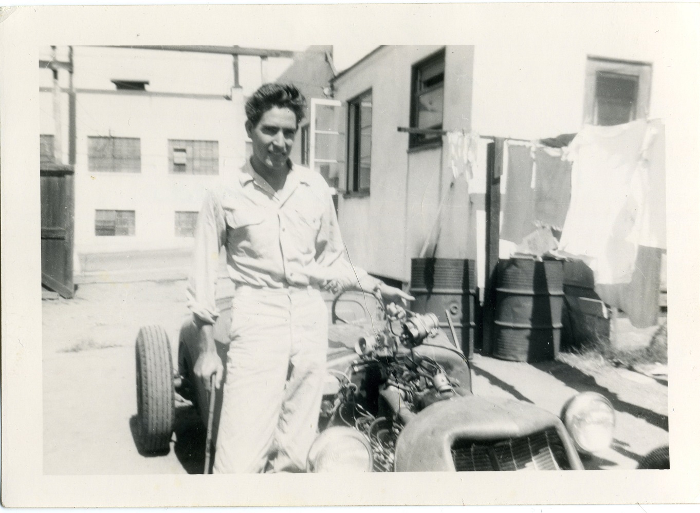 img382  Proud Owner- Ed Emerson holding up broken carbs 9-1948 EAEphto  .jpg