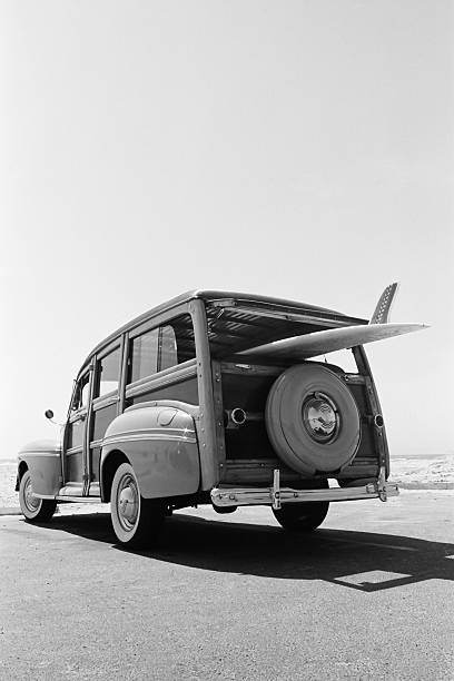 old-woodie-station-wagon-with-surfboard-picture-id182504870.jpg