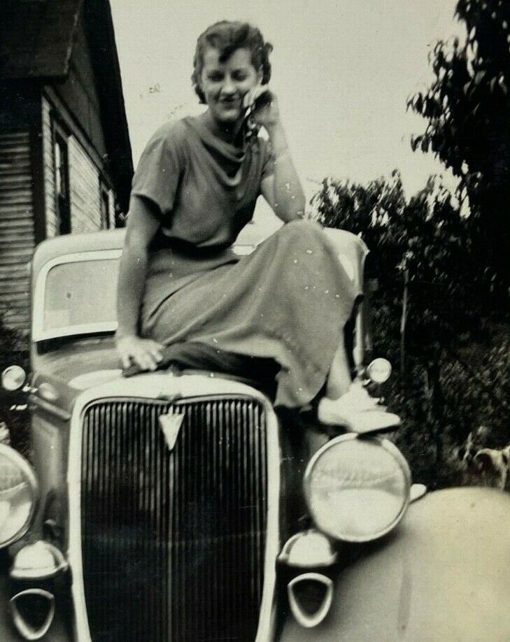 Pretty-Girl-Sitting-On-Hood-Of-Car-B-W-Photograph-.jpg