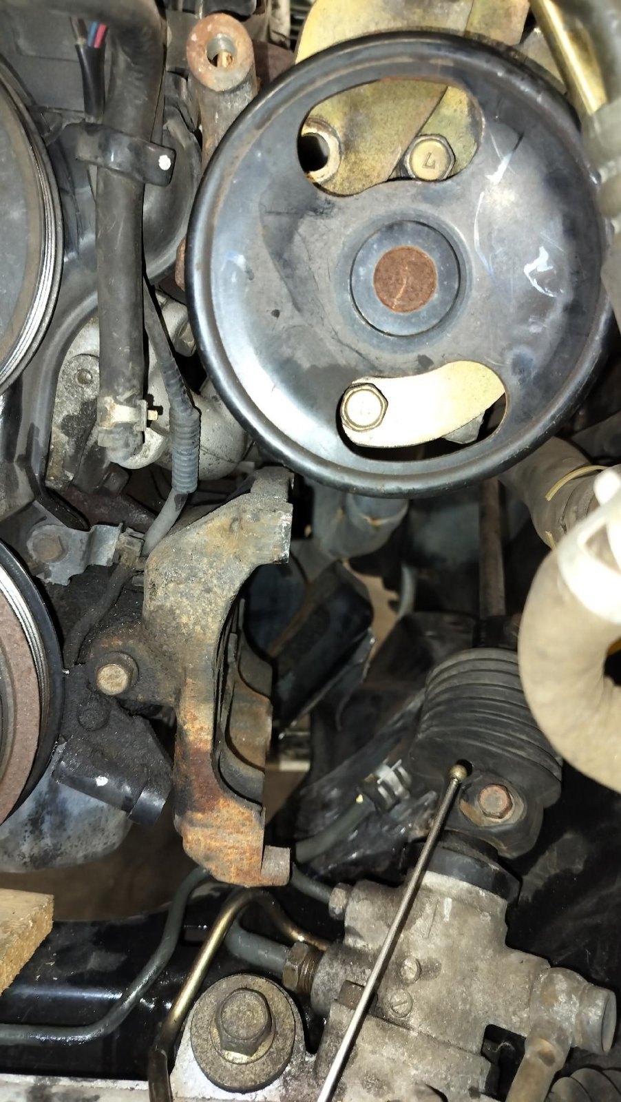 Steering U-joint in the way of of the A-C Compressor showing PS pump.jpg
