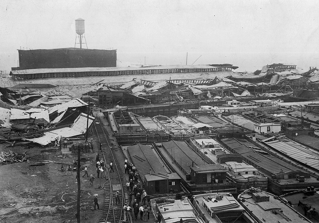 Wrecked_warehouses_and_scattered_debris_after_the_Black_Tom_Explosion,_1916.jpg