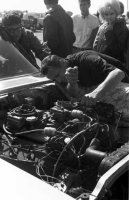 Daddy working on one of his car with Janie in the background.jpg