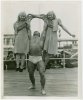 Strongman John Grimek holds up two girls.jpeg