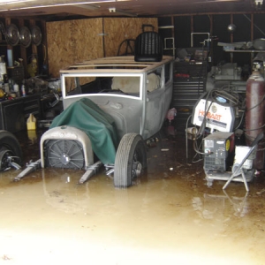 The only pic I have of the top wood and windshield frame.  You can't see it, but I have the shiny valve covers and the carbs and such installed.  The flood has been a bit of an inconvienience.