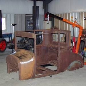 The day I brought the body home.  I'd already started sanding the cowl before I snapped the picture.  You can barely make out the frame in the background.  Frame was almost done before I knew what body would be on it.