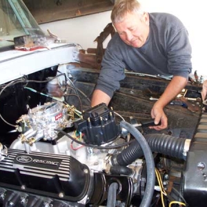 father in-law torquing on something.

You can see the blasted and coated headers there and the customized bracket again.  new radiator for a 75 f100... wasnt an exact fit but very close. GM HEI distro. yeah I know. its GM yadda yadda.