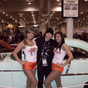 Some lads get all the luck...lol....my son with the Hooter Gals in front of the old 55....Performance World Show 09.