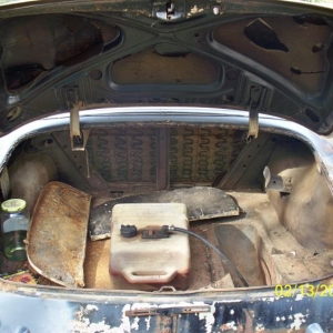 52' Chevy gas tank before i replaced it.  Those are the skirts in the trunk as well.  And no the pickle jar is gas not shine.