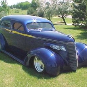 I saw this car in a magazine then saw it in person at the Godguy's show in Des Moines Iowa in 2001 I believe.  1937 Studebaker, 4 door converted to 2 door sedan.  I think the owner is Gerald Lindsey out of Missouri. Not traditional but hell of a neat car.