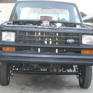 Check out the straight axle. Front disks & spindles are ranger with home made king pins & bushings! The chain is for "hold down" removed for racing.[the "list" is from slanted driveway]