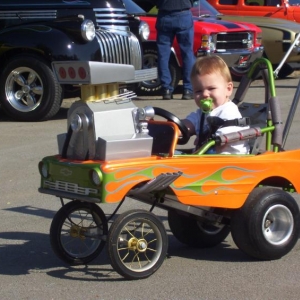 I built this stroller from an old pedal car . I try to take my son Traven to as many car shows as I can. He loves to cruise the fair grounds in his own HOT ROD