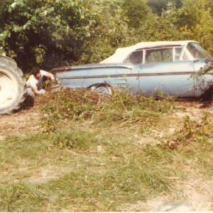That's my dad hooking up a chain from the 1952 Ford Tractor to the 58  and getting ready to drag it home.