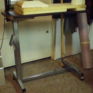 adjustable old bedside table on wheels