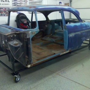 1955 Ford Customline body on cart; ready for soda blasting.