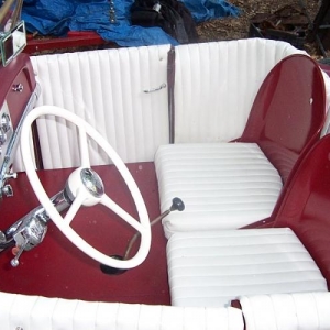 Cheap home made pleated interior with shortened military transport buckets.  Cushy!