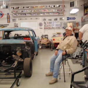 Dad supervising the volunteer labor assembled to mount the body on the cart.