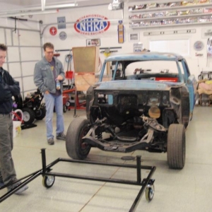 Volunteer labor contemplating mounting the body to the cart.