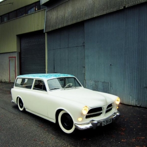 Front quarter. Raised hood nose, frenched grille from a 1960 122, frenched headlights, 1956 Dodge bumperguards, peaked hood, welded seams, rounded hood corners, laced roof