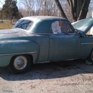 Coupe with hubcaps and beauty rings.