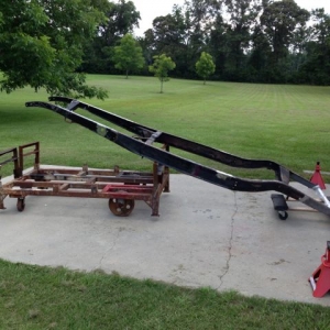 Loading the frame onto a dolly.  We fabricated the dolly out of some junk that was laying around.  The idea is to be able to roll things around in the barn.  I like to work outside when the weather lets me.  Rear frame horns are welded in.